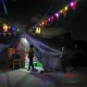 decorated tents in light of displacement