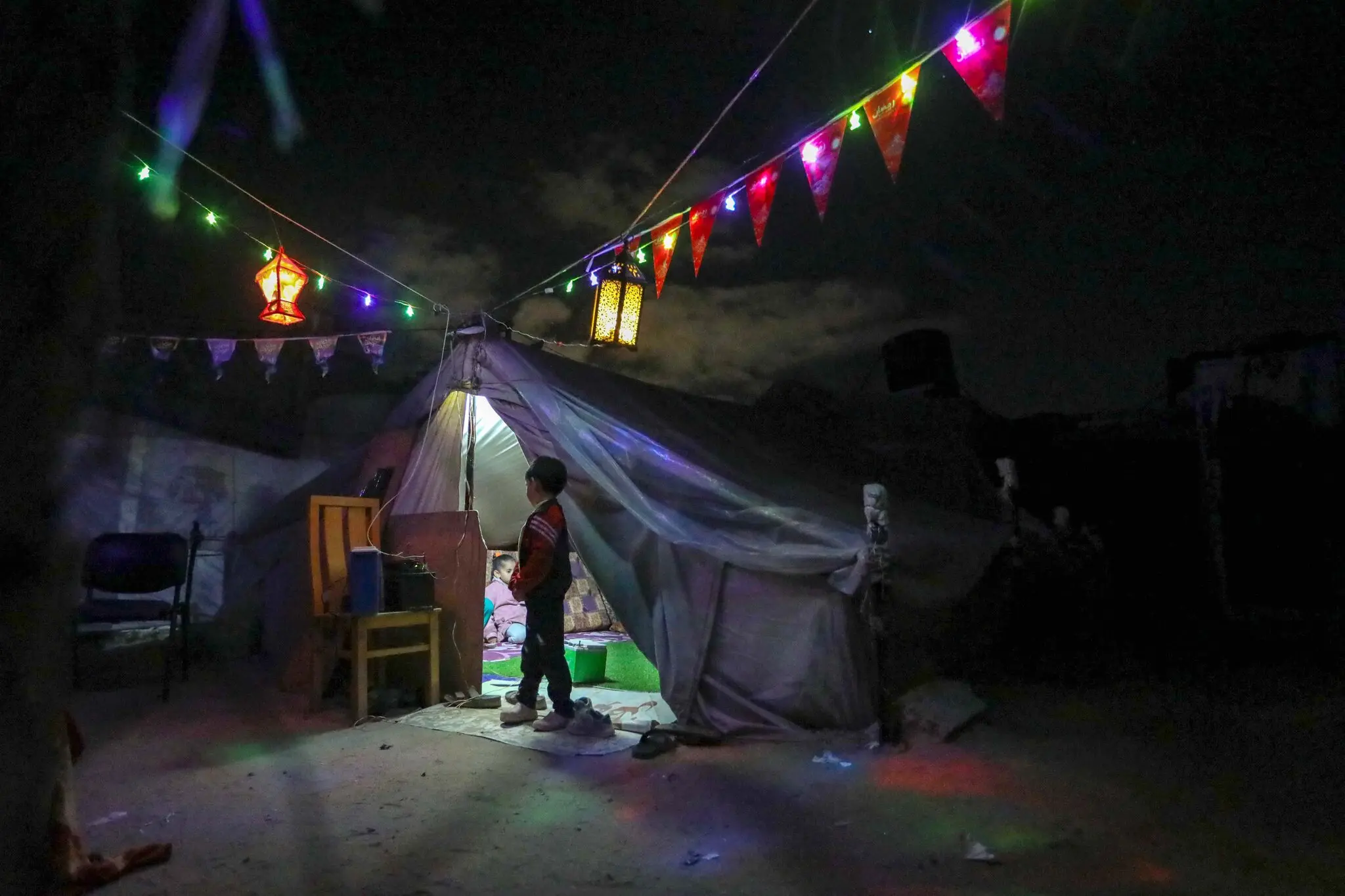 decorated tents in light of displacement